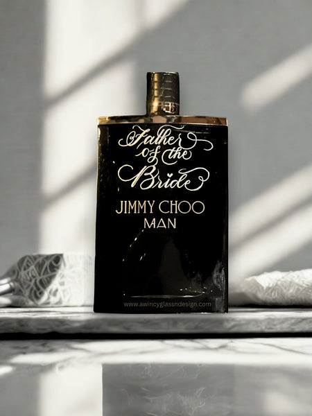 Jimmy Choo Man engraved cologne bottle on a dark stone surface, photographed for a father-of-the-bride great for wedding gift; custom engraving available at awincyglassndesign.com